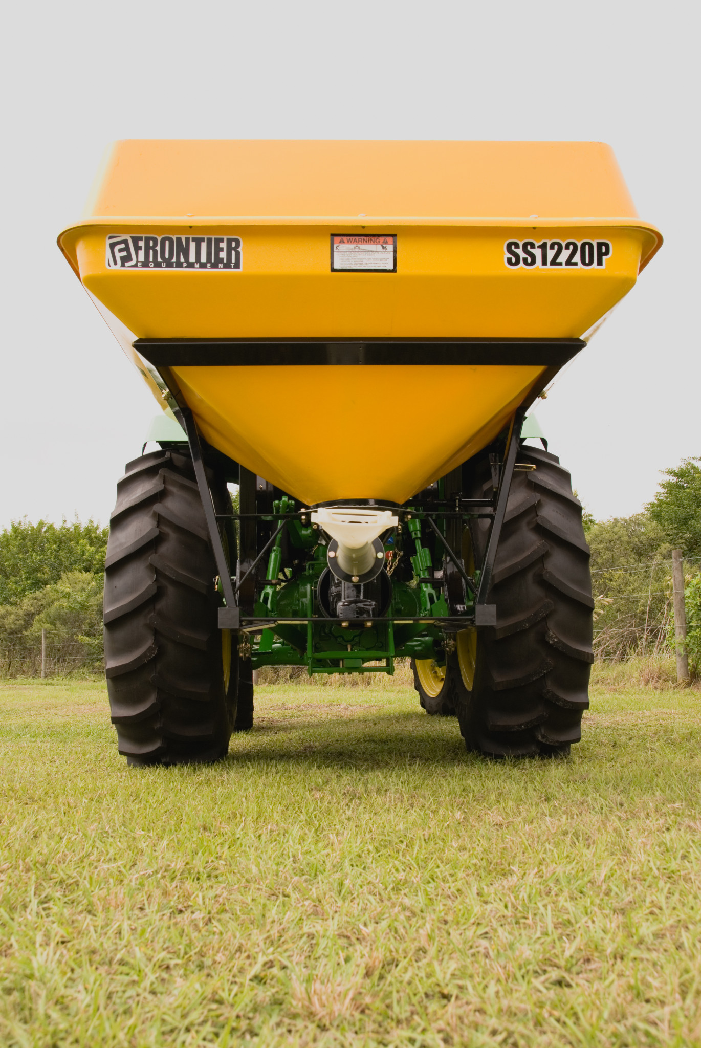 Rear view of SS1220P Pendular Spreader mounted on the back of a tractor