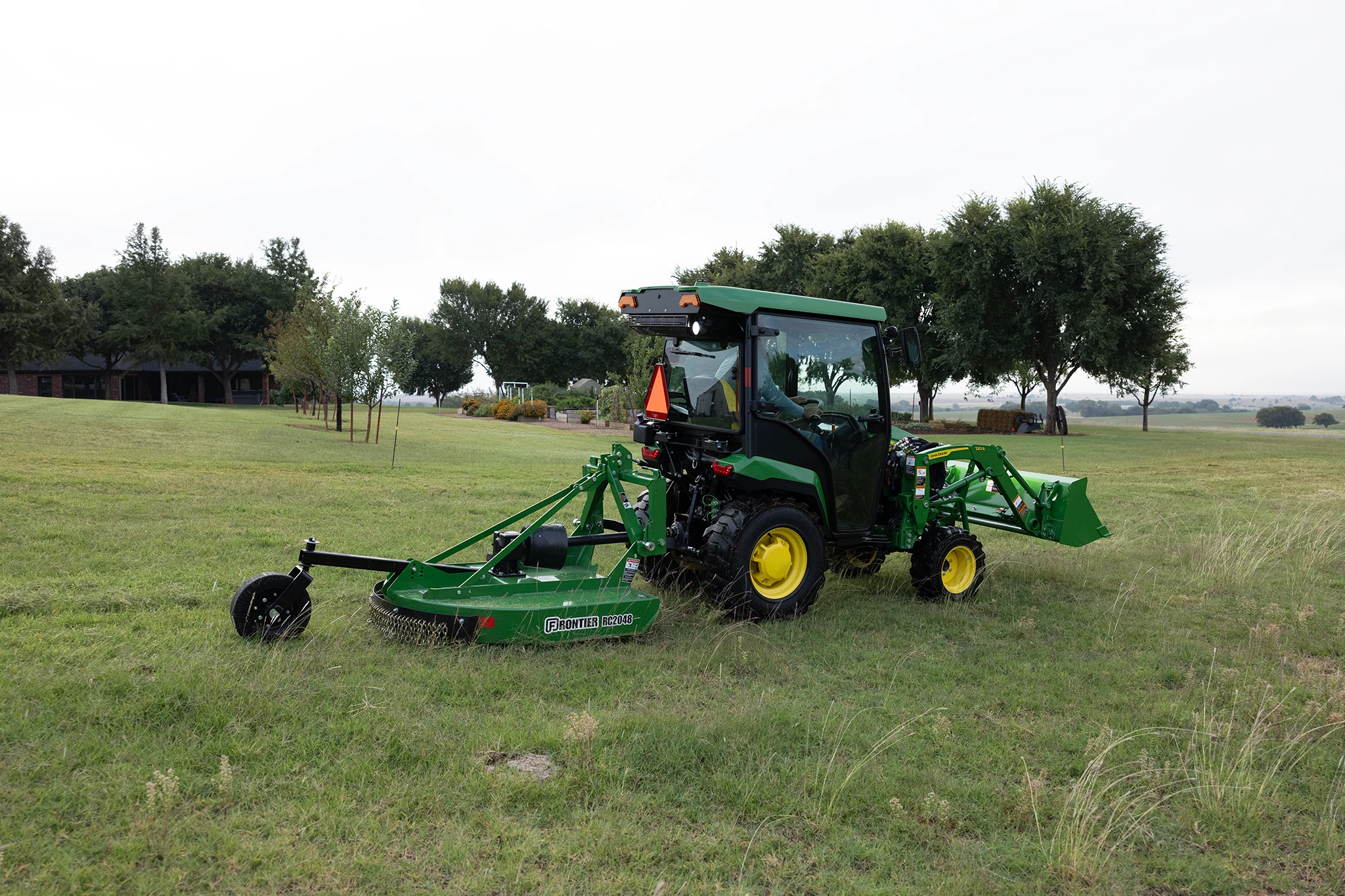 RC2048 Rotary Cutter on utility tractor in grassy field