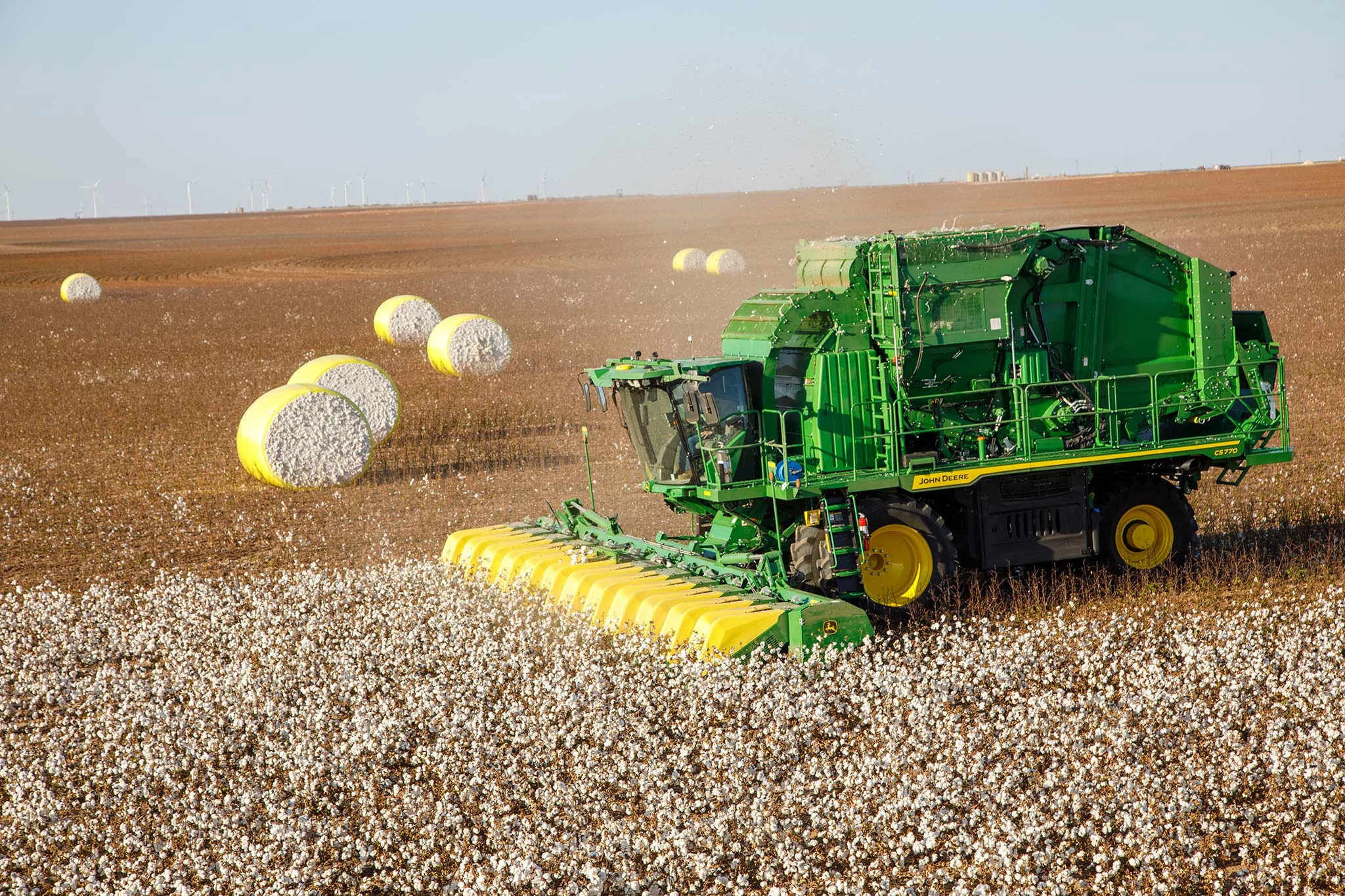 Side left view of a cotton harvester working in a cotton field