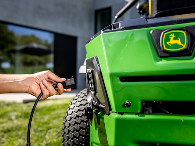 Hand plugs electrical cord into Z370r Residential Mower