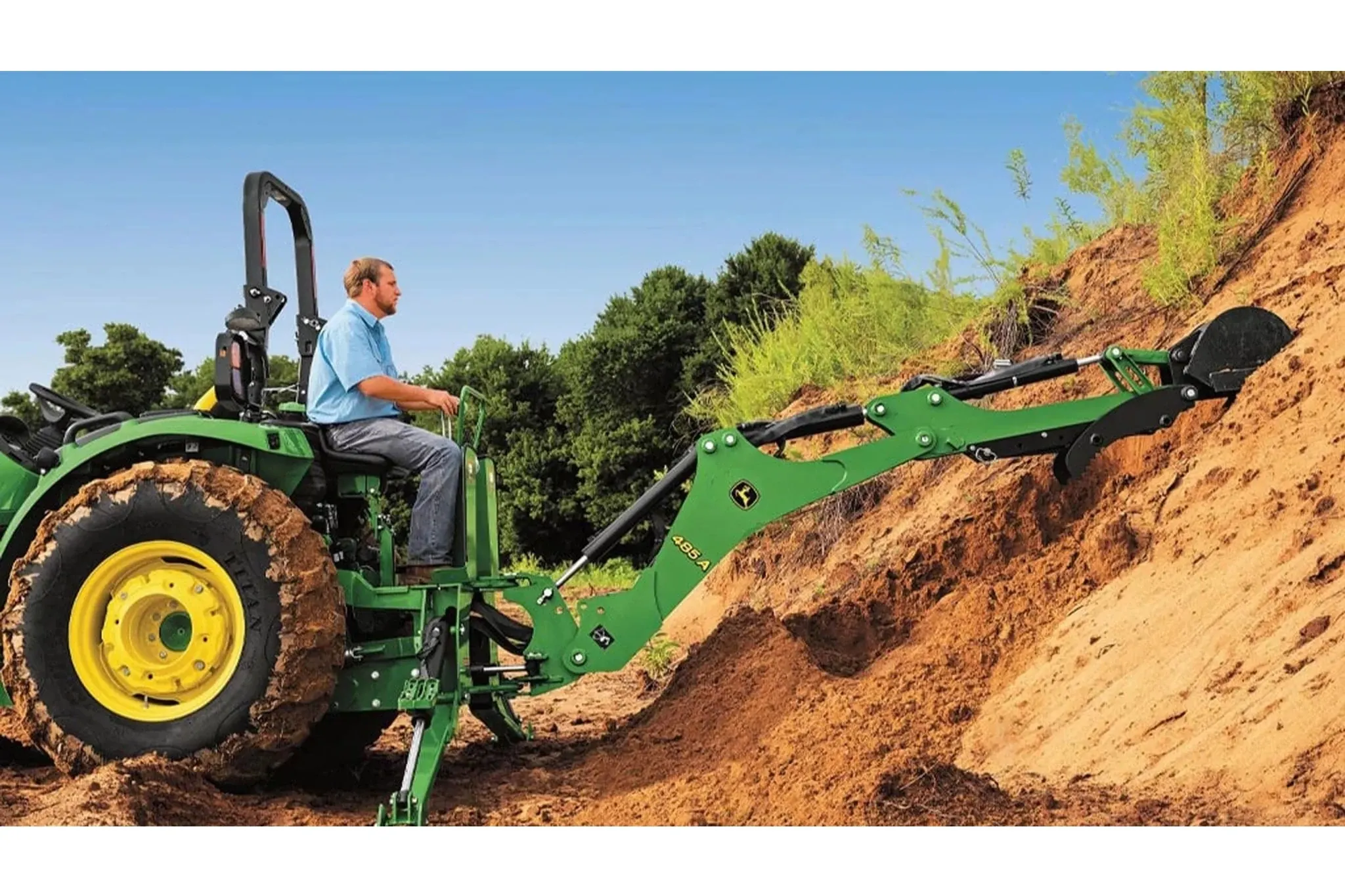 farmer on a 4044R Compact Tractor enforcing a dirt hill