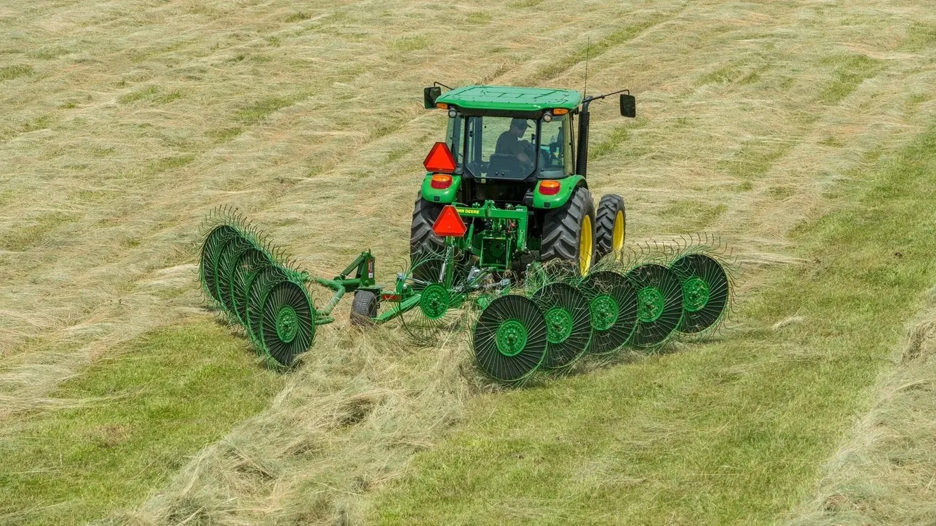 Farmer raking grass with a WR00 Wheel Rake