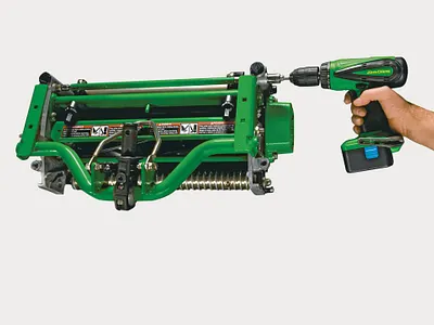 Studio close-up of hand operating drill on Walk Greens Mower