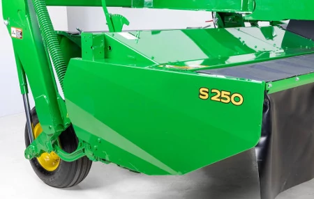 Studio close-up of the right side of a green-painted S250 Side-Pull Rotary Mower-Conditioner