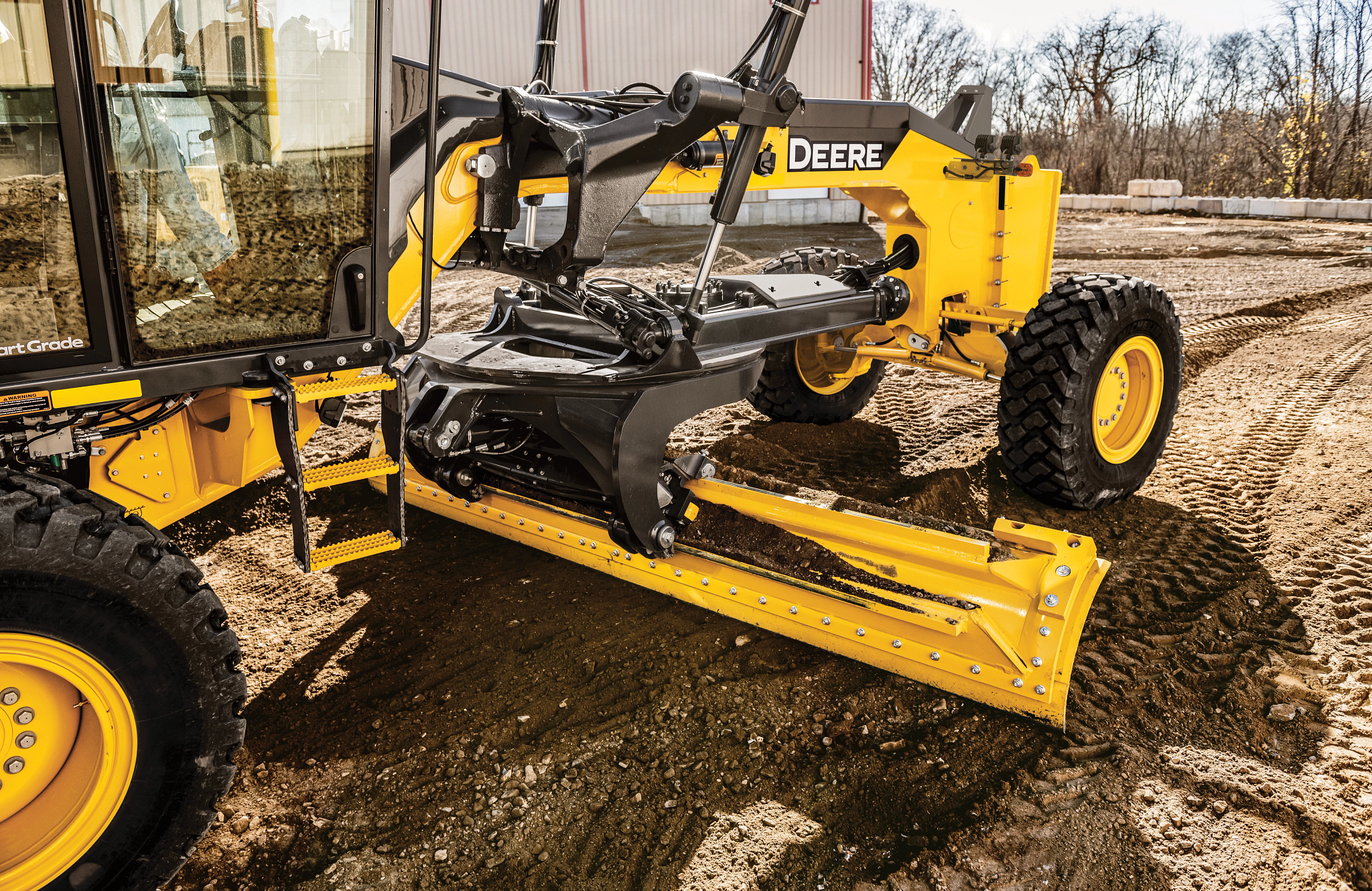 Front left close up of an 870P Motor Grader on dirt lot