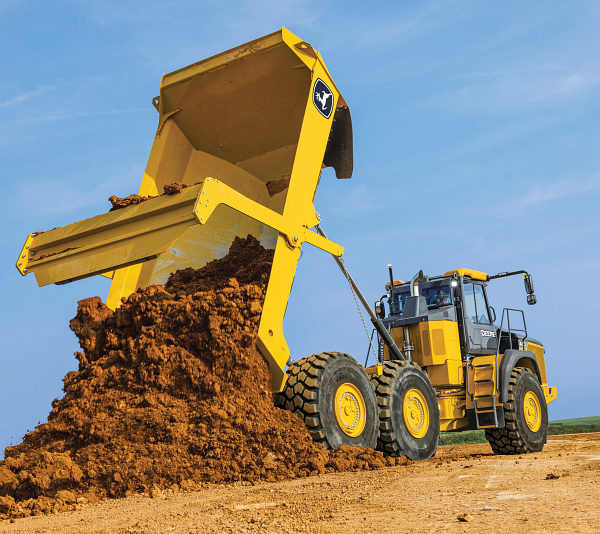 John Deere wheel loader moving material at a construction site