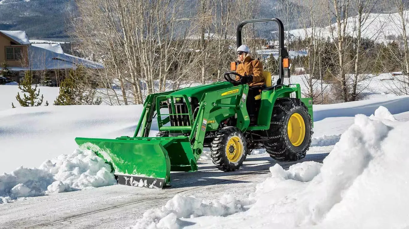 AF12G Series Front Blade clearing snow in a driveway