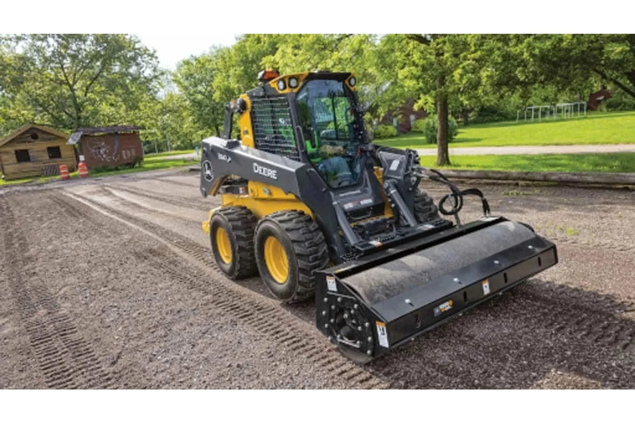 334 P-Tier Skid Steer Loader with vibratory roller attachment compacting fresh dirt in a park