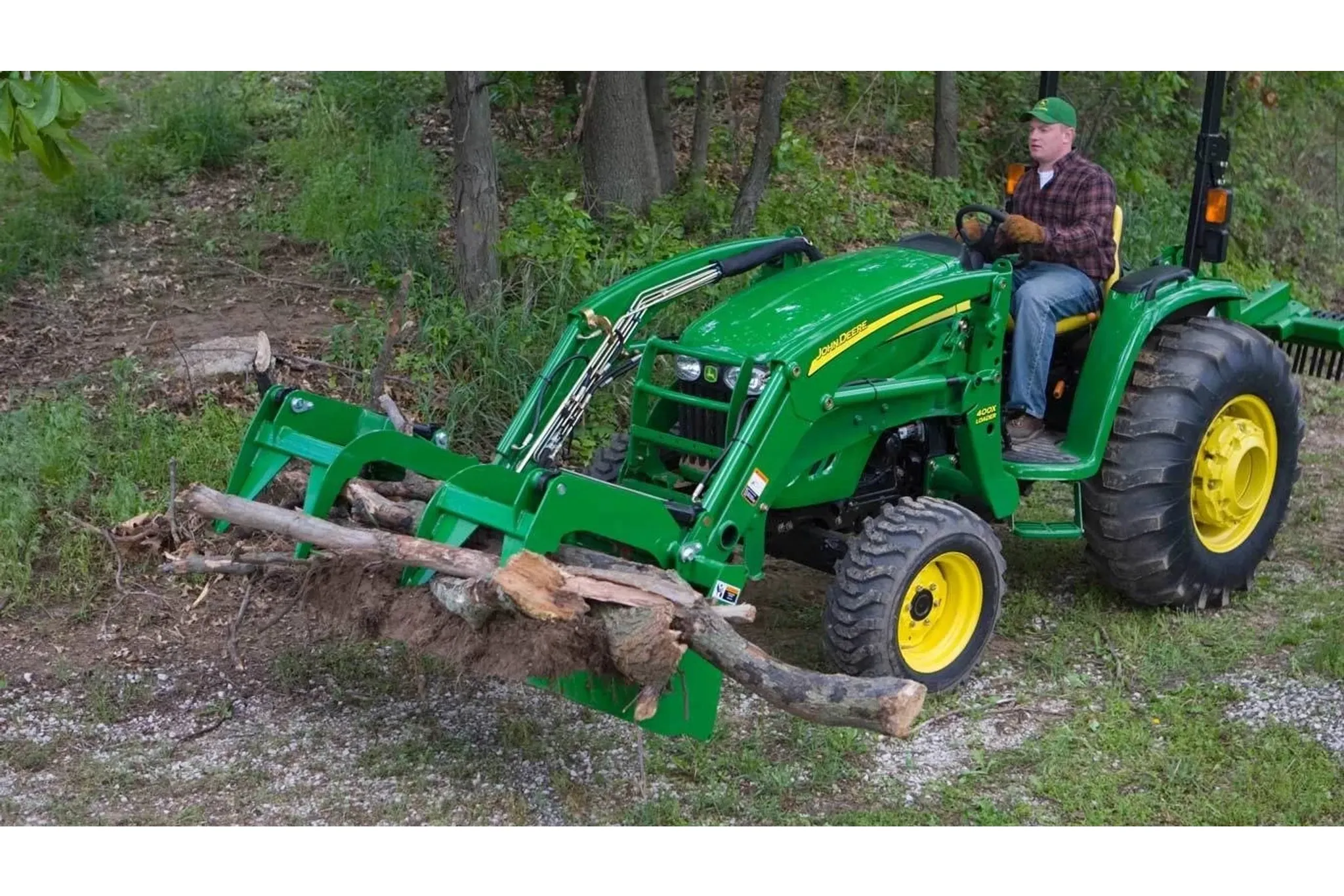 farmer with Frontier AD11 Series Debris Grapple on a tractor moving logs