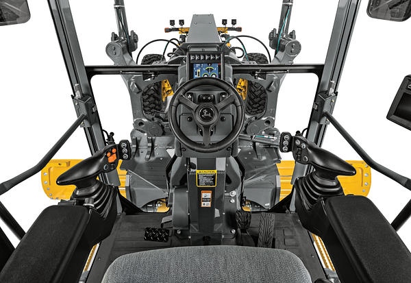 Front, in-cab view of P-Tier Motor Grader Dual Joystick controls and steering wheel