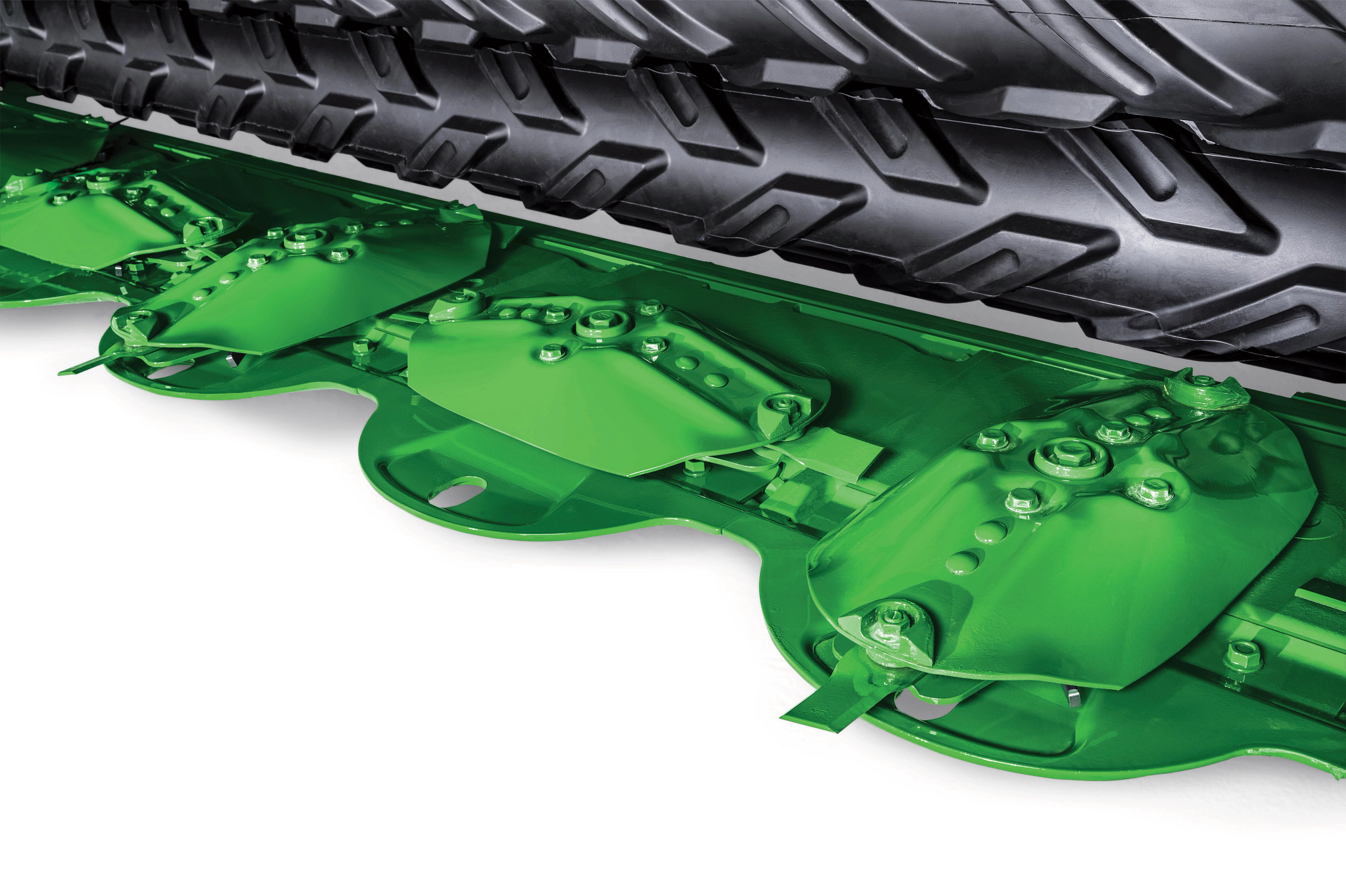 Close‑up of John Deere windrower cutterbar showing green disc mower modules and protective shields beneath the front tire, highlighting the cutting system components against a white background.