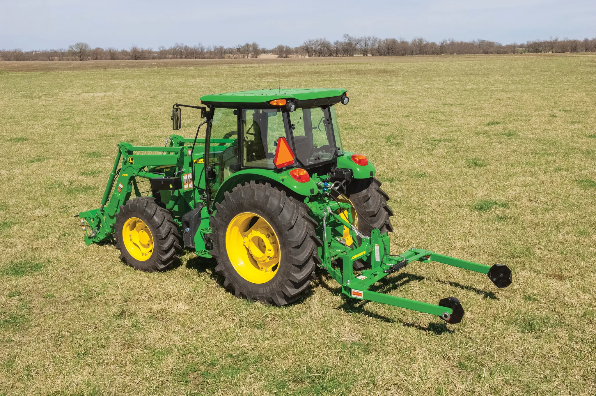 a Tractor with a BU1060 Bale Unroller working in a field