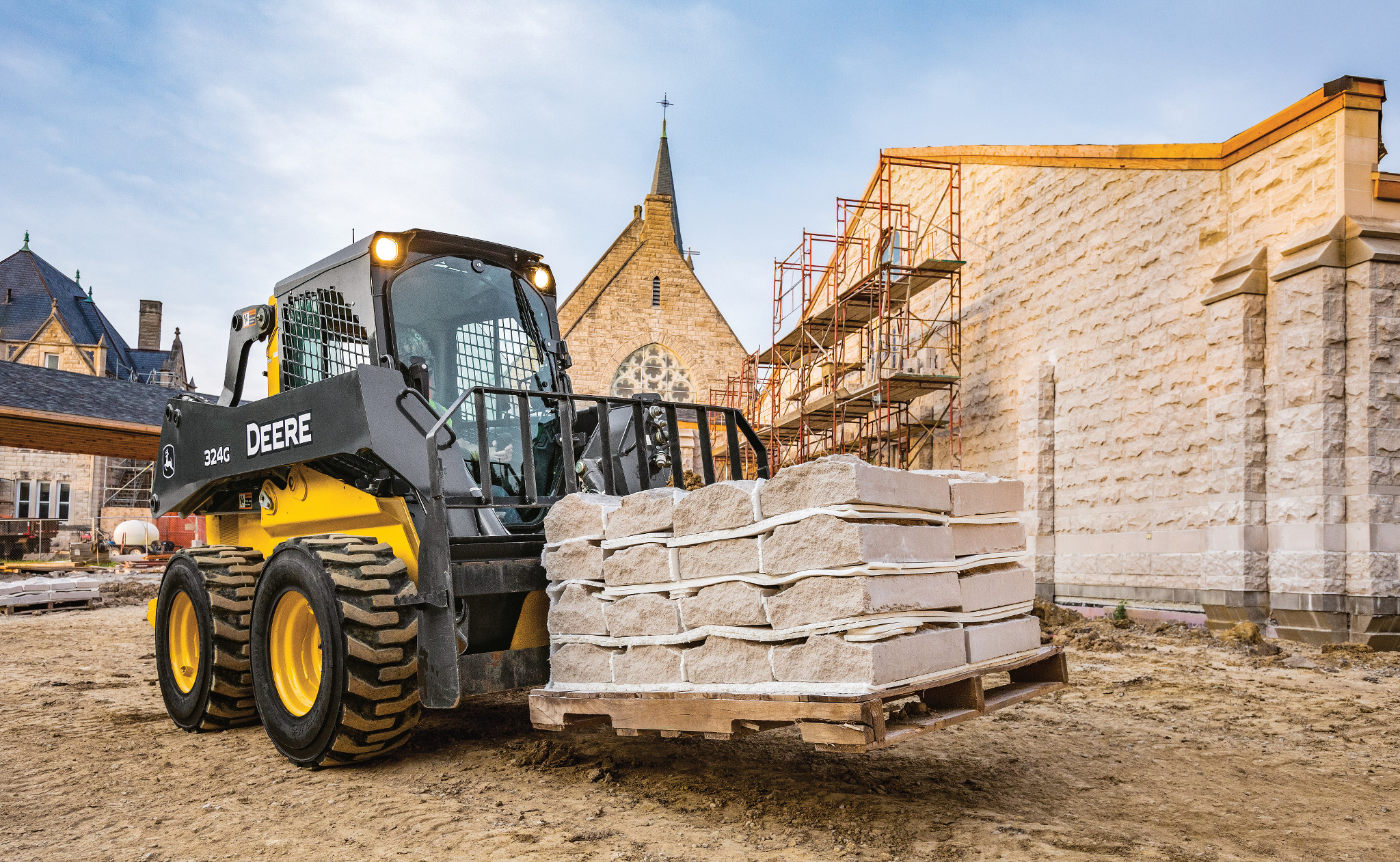 John Deere Skid Steer Moving Stone at a Church Construction Site