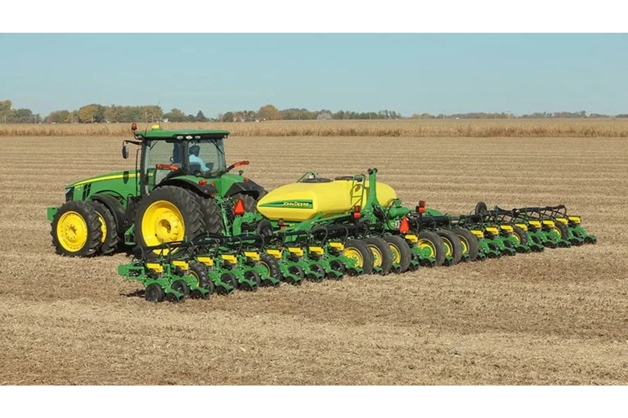 DR24 Planter behind a tractor in a field