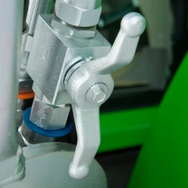 Close-up of a loader's silver hydraulic shut-off valve