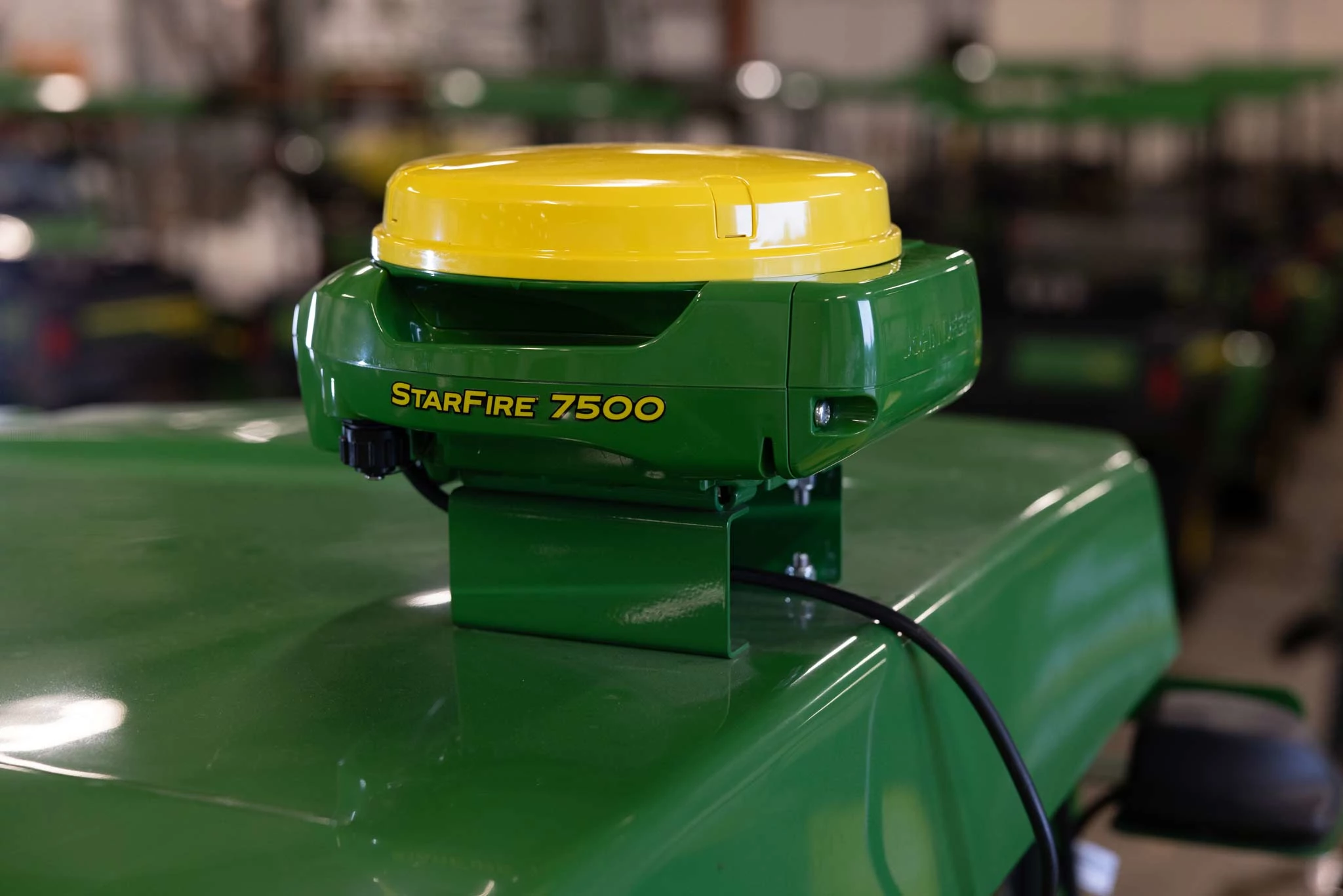 Close-up of the corner of the green roof of a 2020A ProGator with a yellow and green StarFire 7500 mounted there