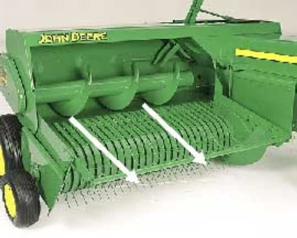 Front right studio view of a green, wheeled hay compressor from a small square baler with two white arrows point outward from the auger