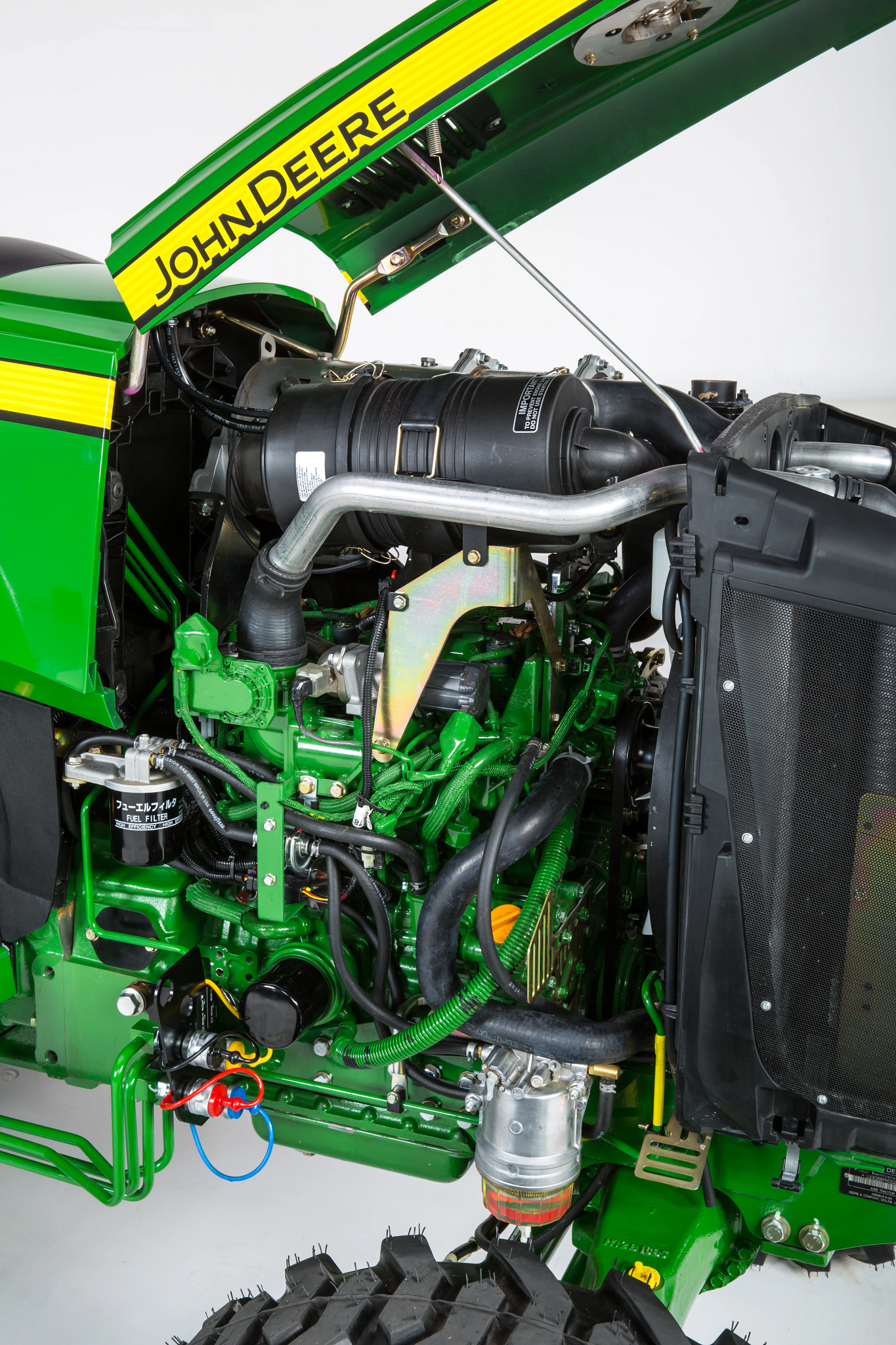 Side studio view of a 4066R open station tractor's uncovered Yanmar® Diesel Engine