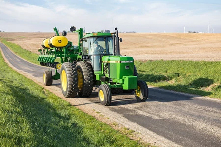 Front right view of a 1745 Planter in Transport Mode on a country road