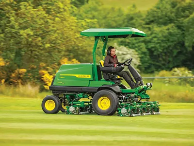 Woman operates a 7700A E-Cut fairway mower in the field