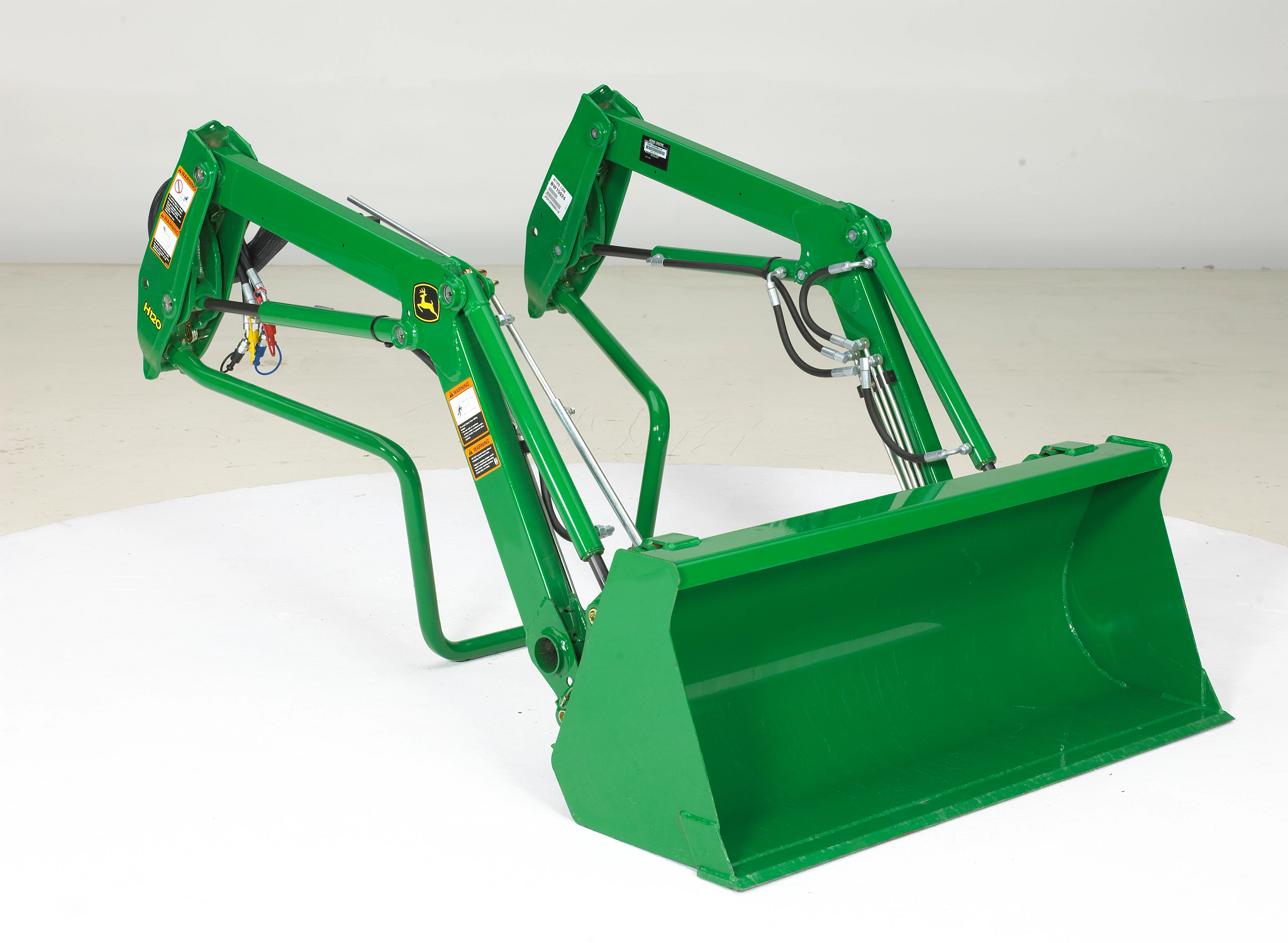 Front right studio view of an H120 loader in Quik-Park™ mounting position