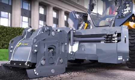 Front left view of a CP24G Cold Planer on the front of a loader working along a curbside