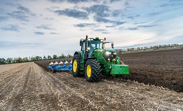 Front right view of tractor pulling a tillage implement through a field