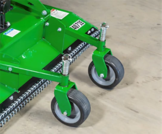 Close‑up of the front caster wheels on a green grooming mower deck with adjustable height brackets