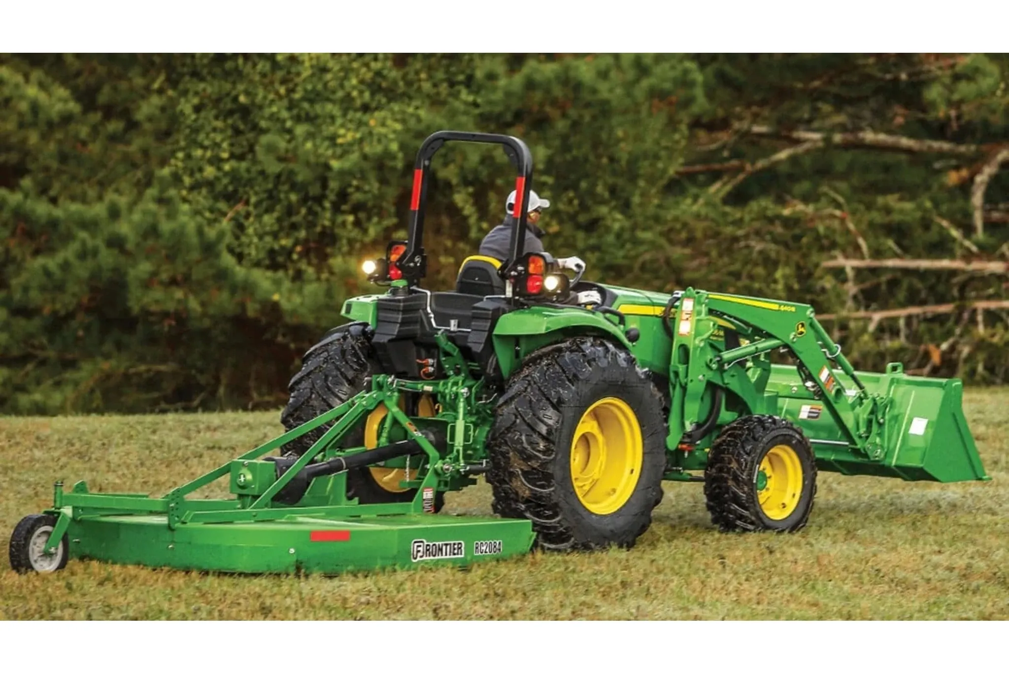 4066M Heavy Duty Compact Tractors with a close up of a tractor with a trailer on a field