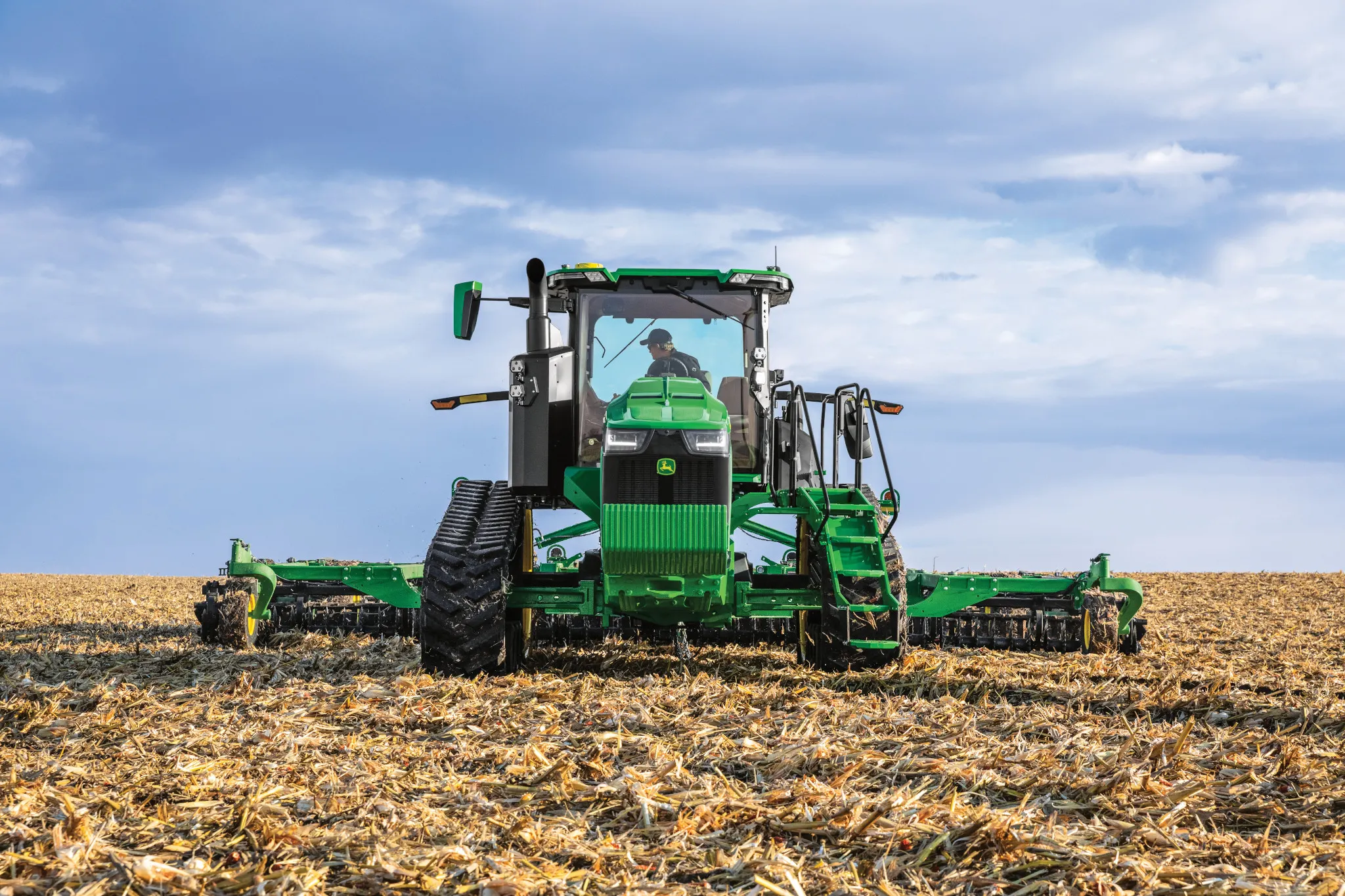 John Deere 8RT tractor pulling a planter in the field — Koenig Equipment