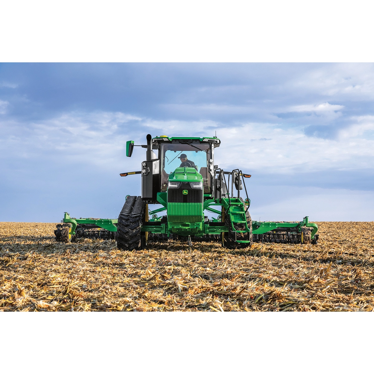 John Deere 8RT tractor pulling a planter in the field — Koenig Equipment