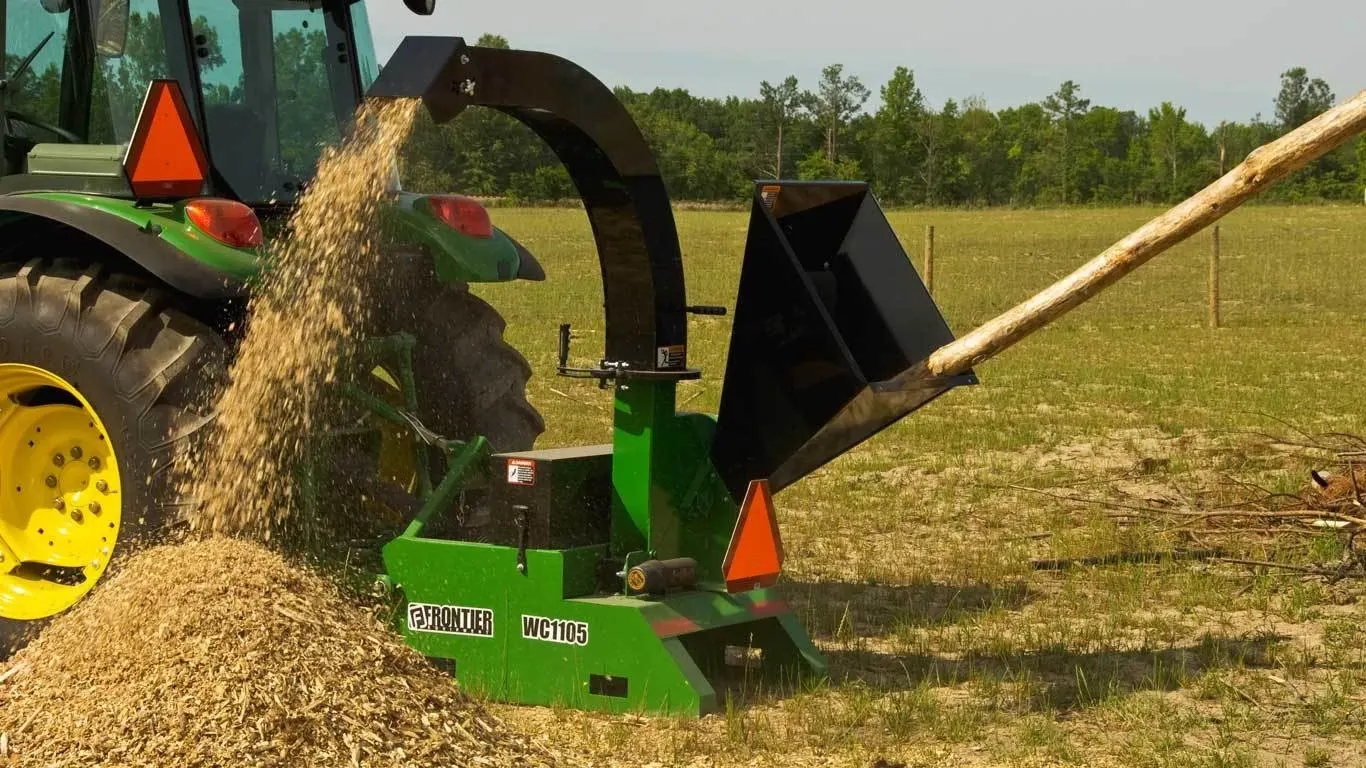 WC11 Series Wood Chipper chipping logs in a field