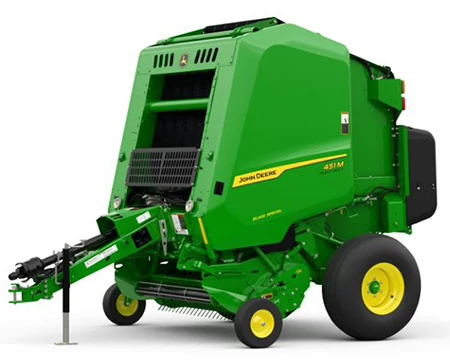 A green John Deere 451M Round Baler shown from a front-side angle, featuring its pickup assembly, bale chamber, and hitch components