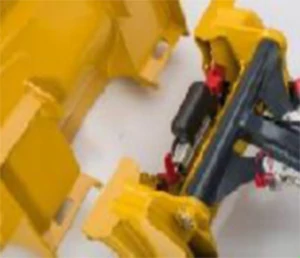 Overhead, close-up of yellow and black implements involved in the skid steer Quik-Tatch™ coupler