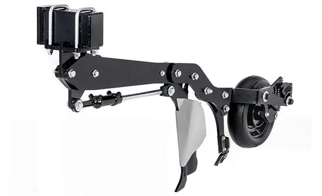 Close-up of an air hoe drill opener assembly featuring a metal shank with a protective wear guard and a gauge wheel positioned behind it