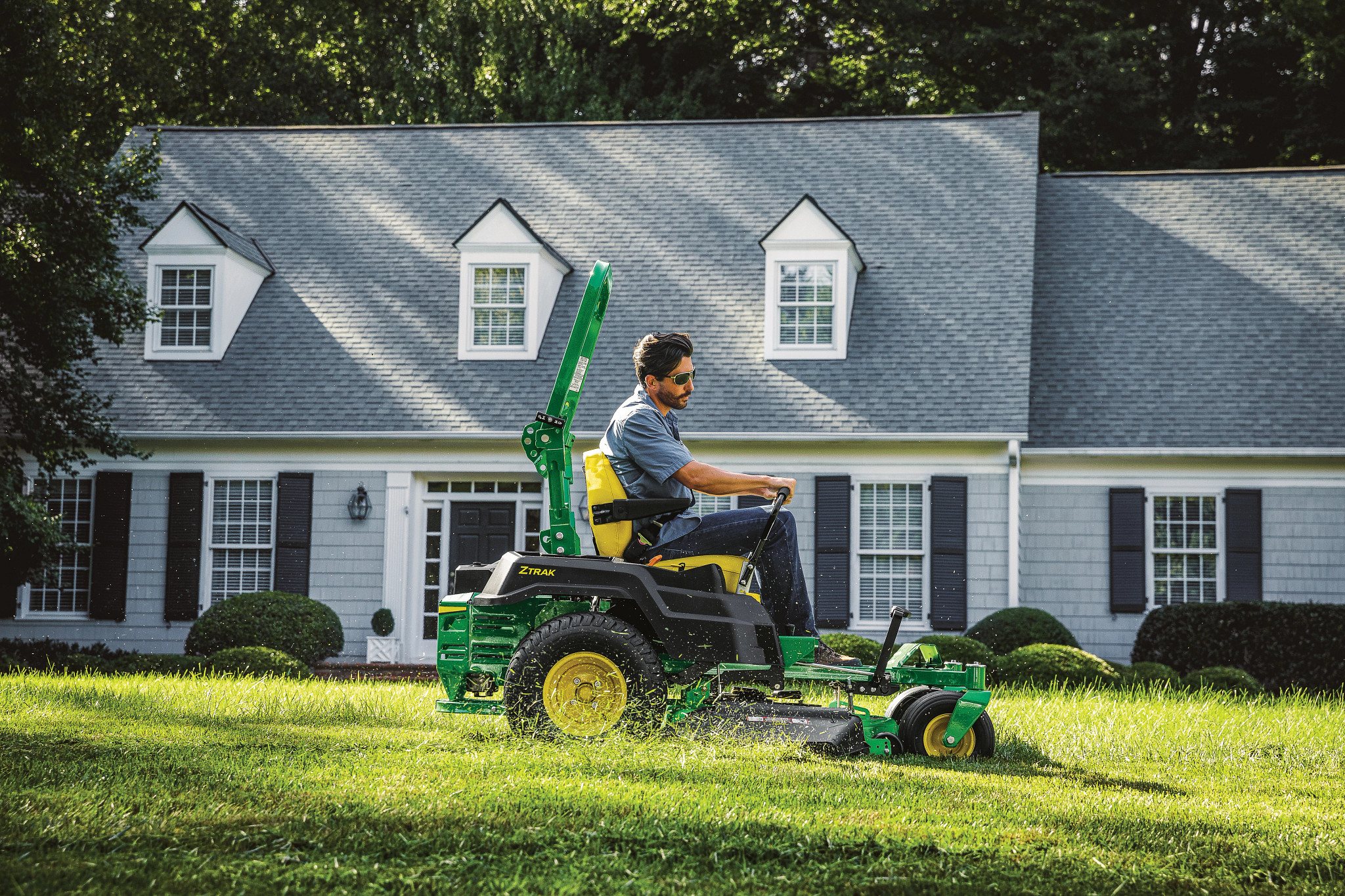 John Deere Z515E mowing a residential lawn