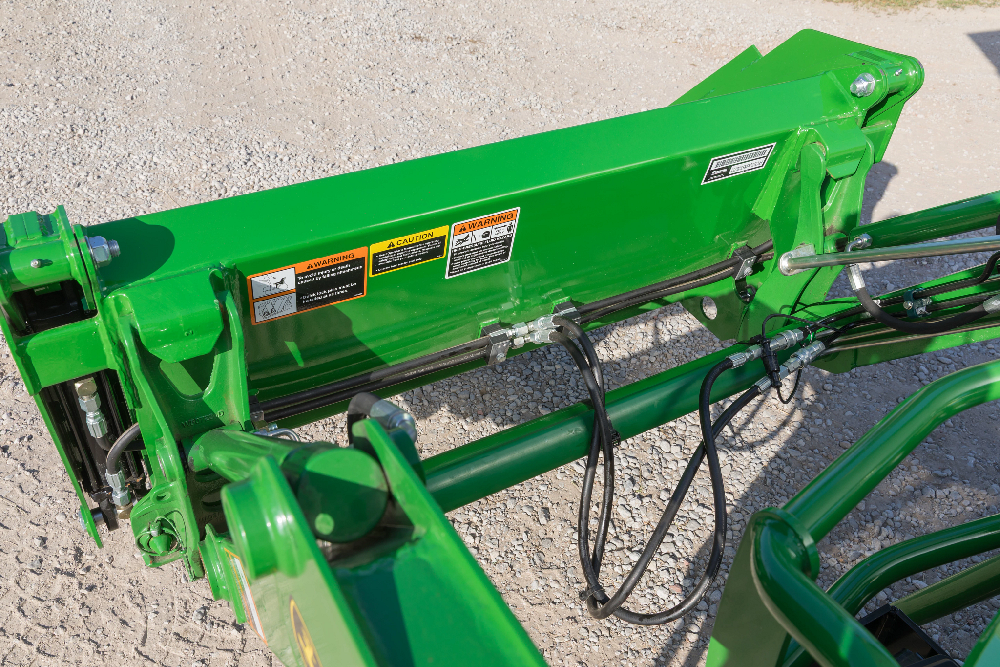 Top left view of the quick attach hydraulic connection of a loader with an AY11F 4-in-1 bucket