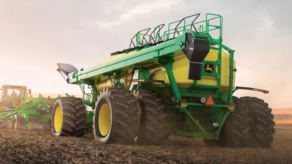 John Deere air cart and tractor working in the field — Koenig Equipment