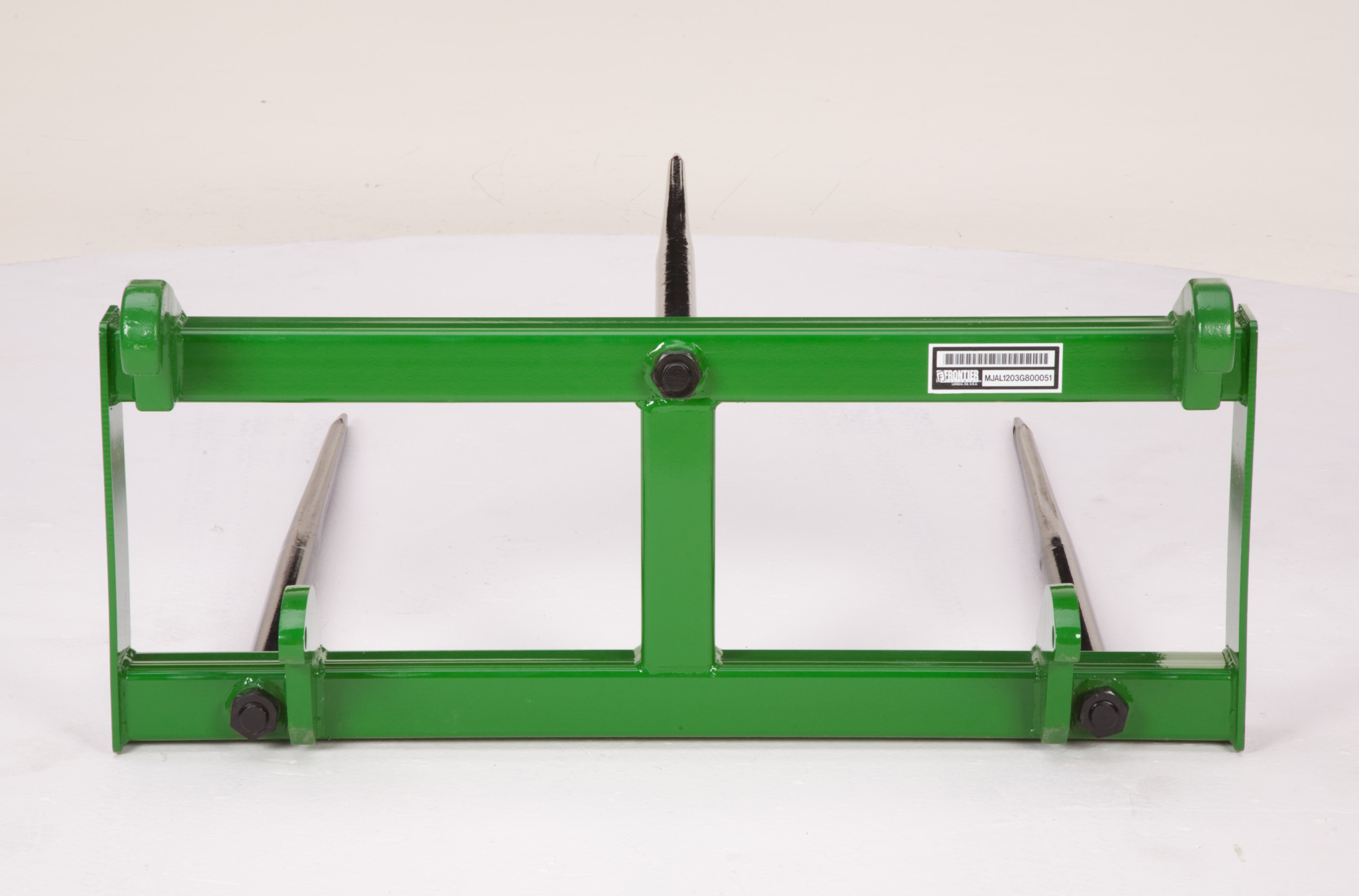 A green pallet‑fork frame with two long steel tines extending forward, displayed against a plain background.