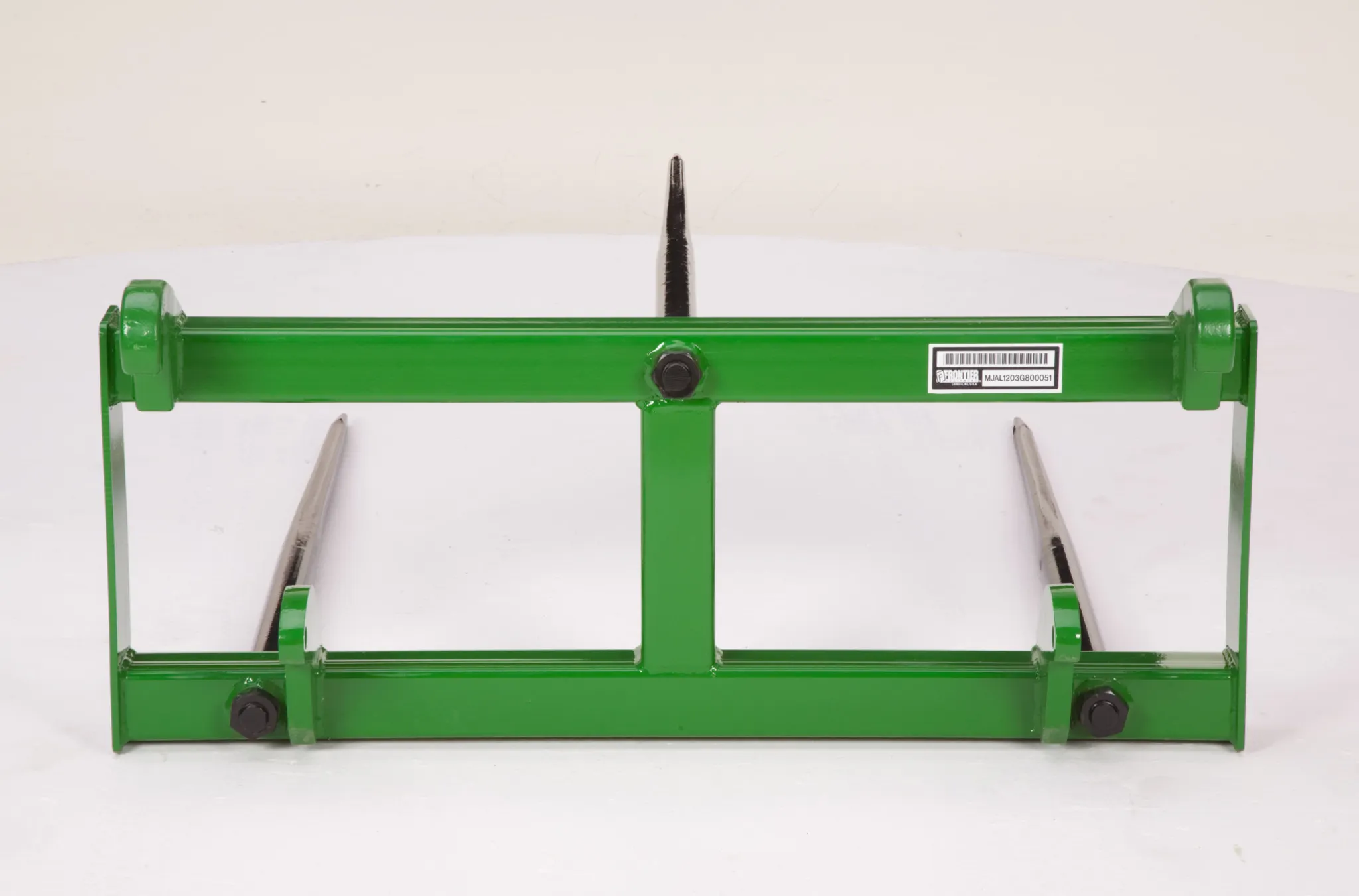 A green palletâ€‘fork frame with two long steel tines extending forward, displayed against a plain background.