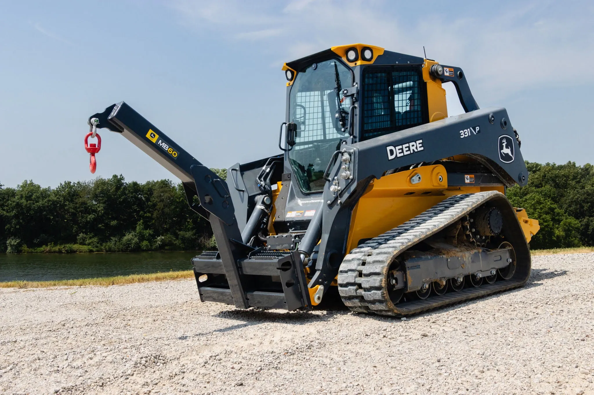 mb60 material boom equipped on a skid steer in the field