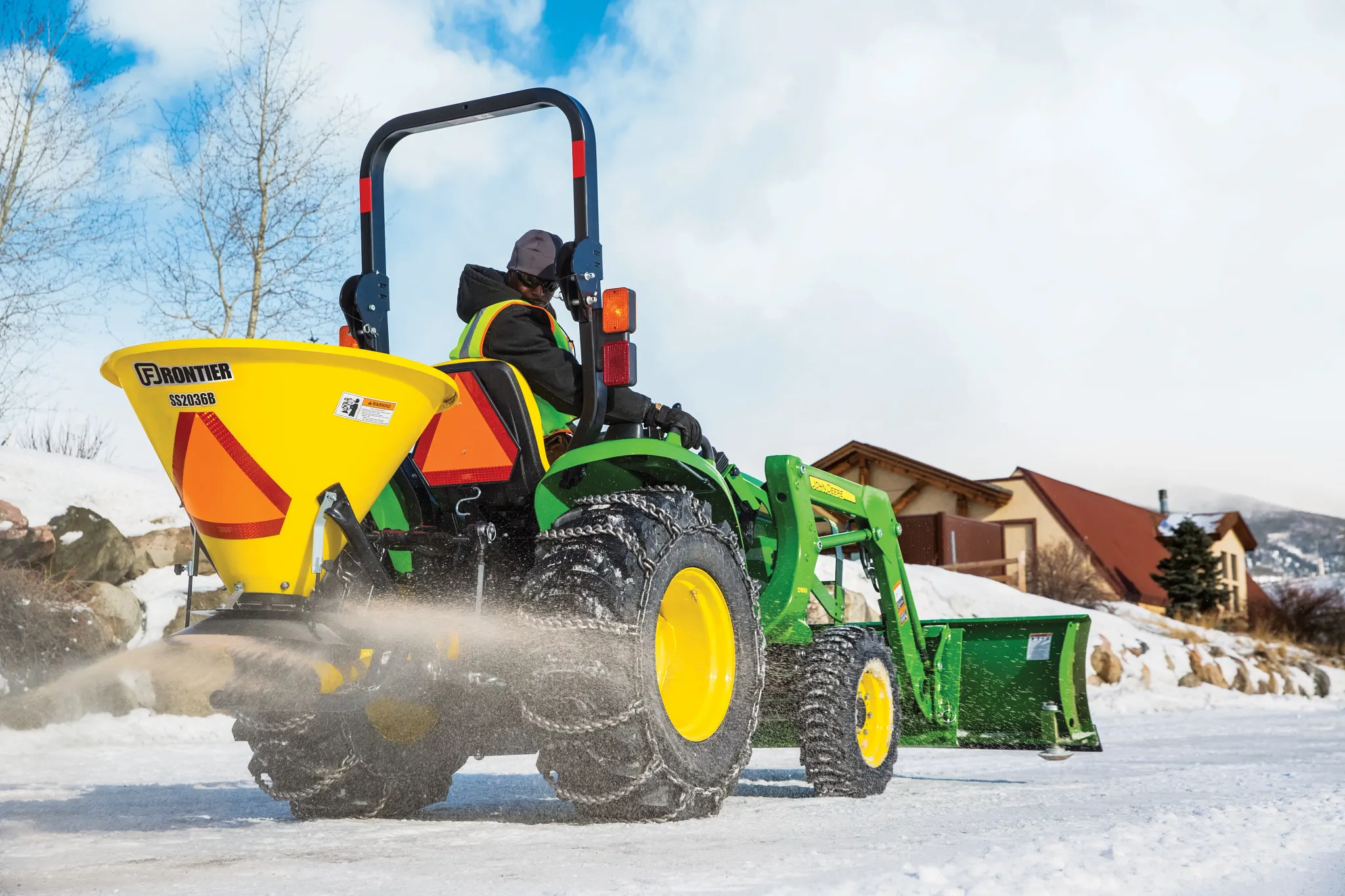 Field shot of spreader with salt on snowy drive