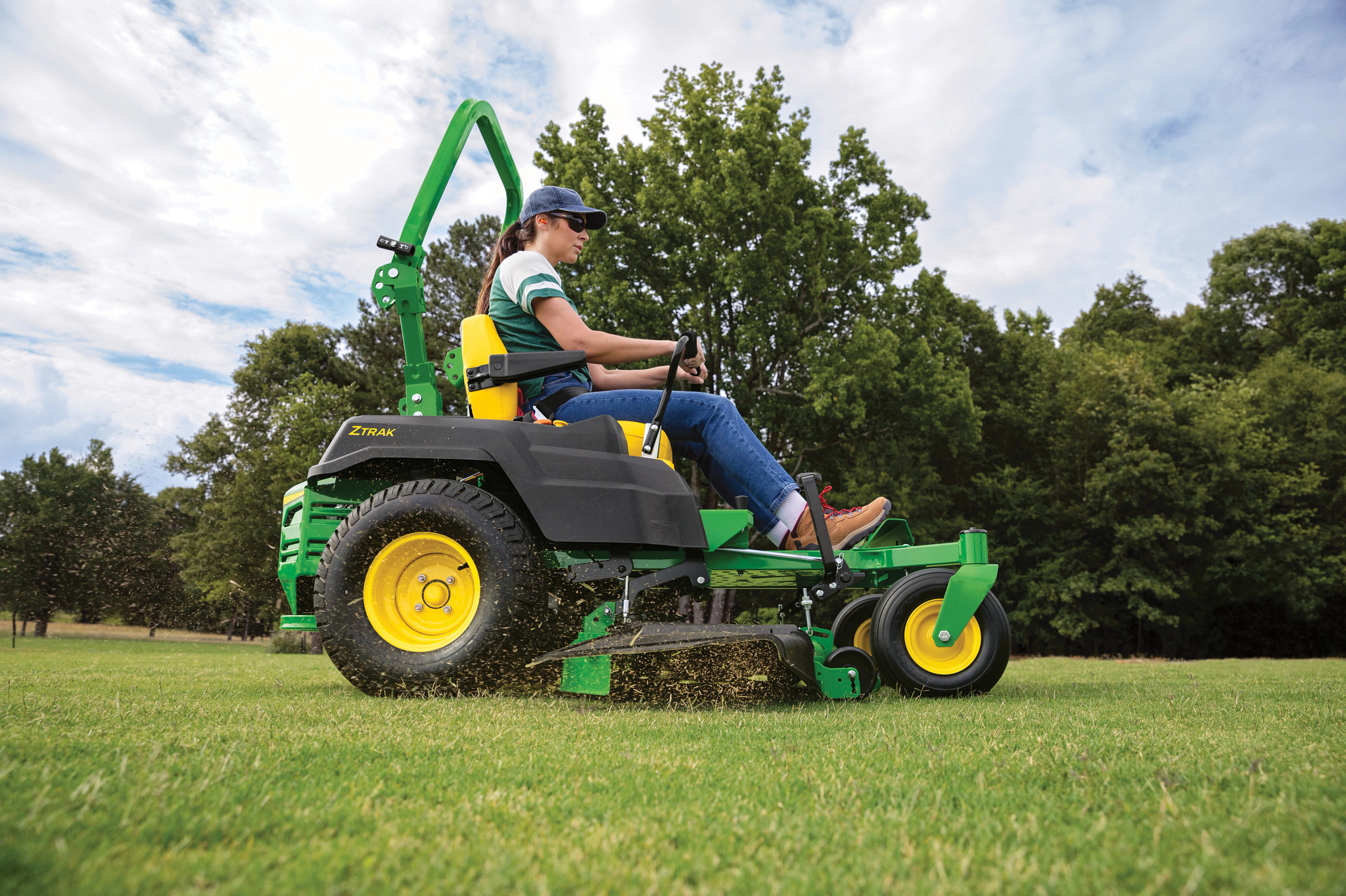 Customer mowing a lawn with a John Deere Z515E 54-inch zero-turn mower