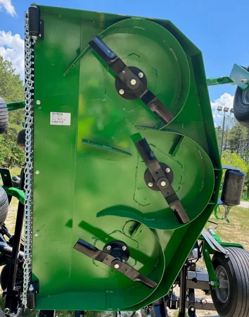 Front view of the underside of an FM40 series flex-wing grooming mower, featuring deck baffling around the three blades