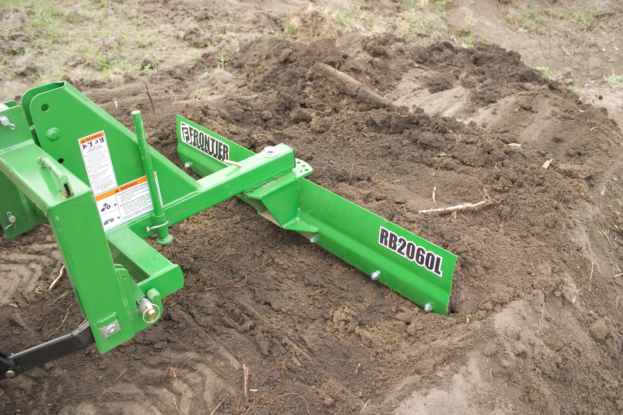 Front right view of an RB2060L Rear Blade at work in dirt