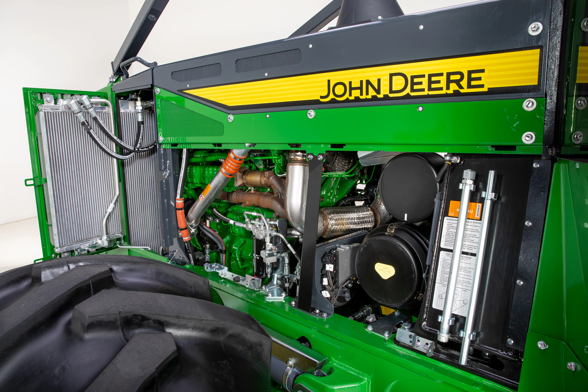 Side view of a 768-III bogie skidder's engine housing, featuring removable panels and swing-out coolers