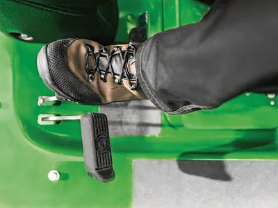 Foot operating Twin Touch™ transmission pedal on Front Rotary Commercial Mower