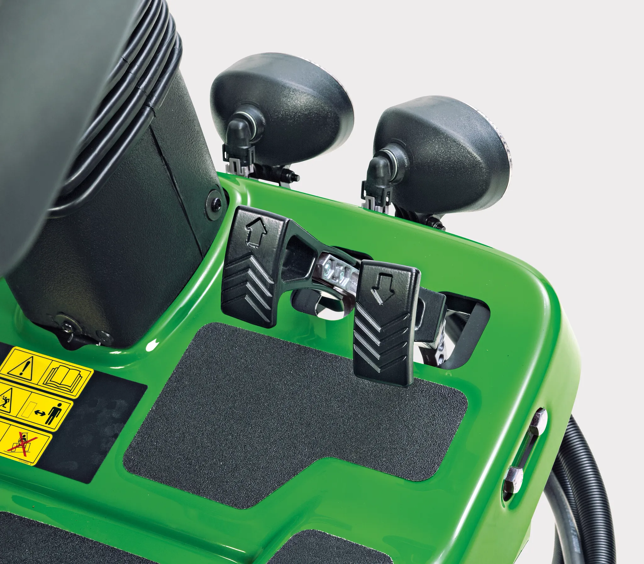 Close-up view of pedals on a fairway mower in studio