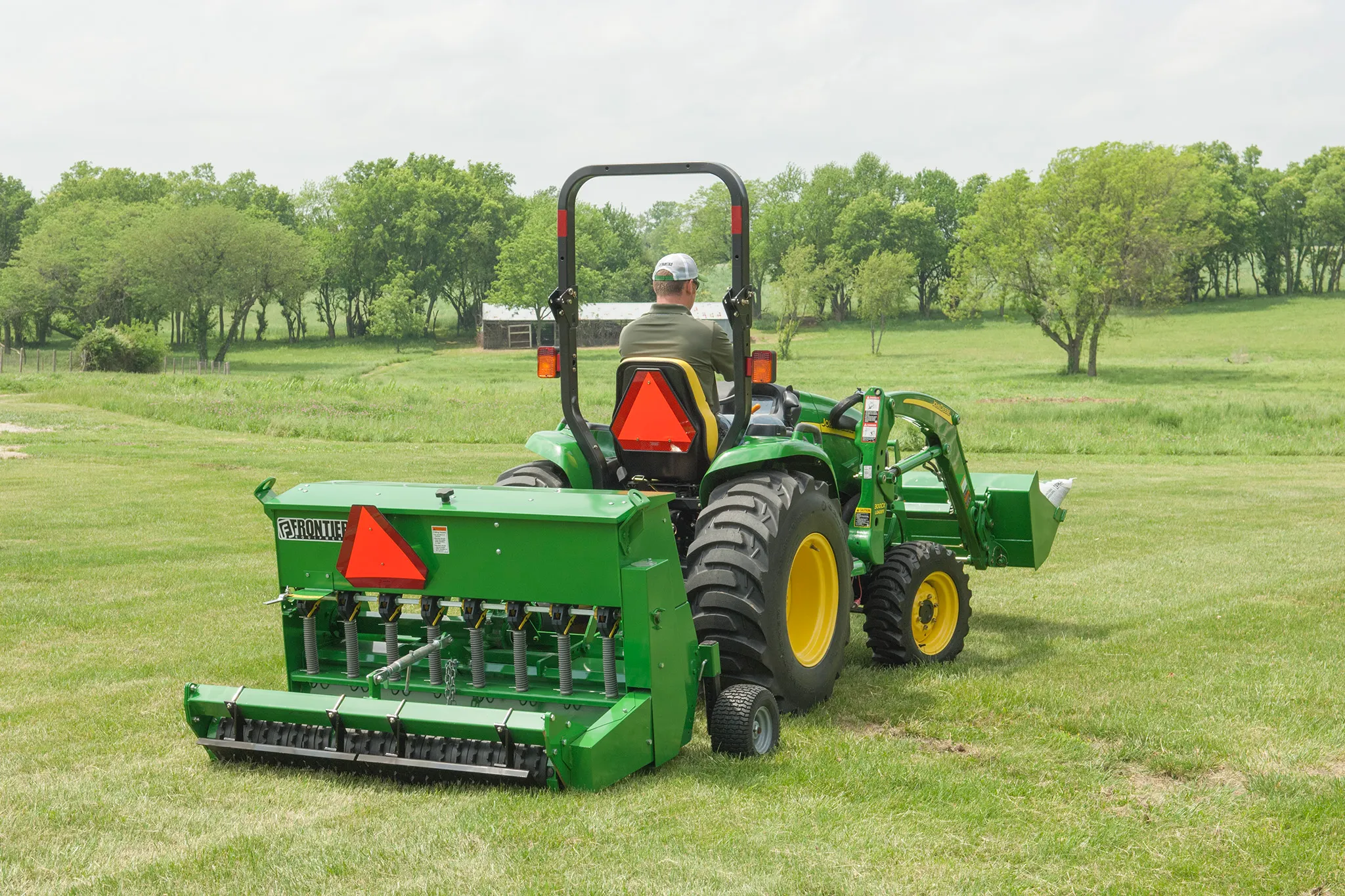 Rear view of TR2058 Turf Renovator on Utility Tractor on a golf course