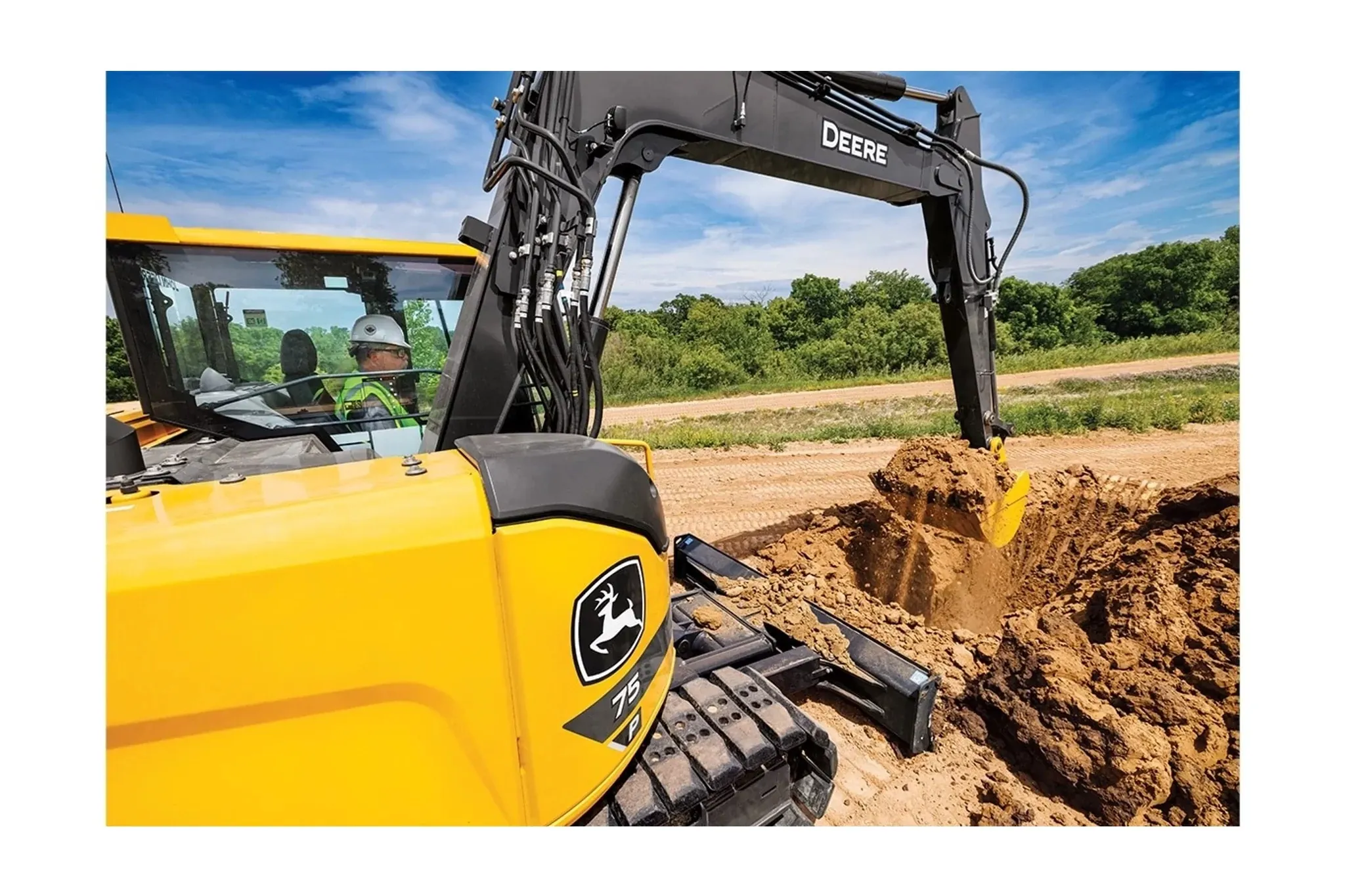 Construction worker digging dirt with a 75 P-Tier Excavator